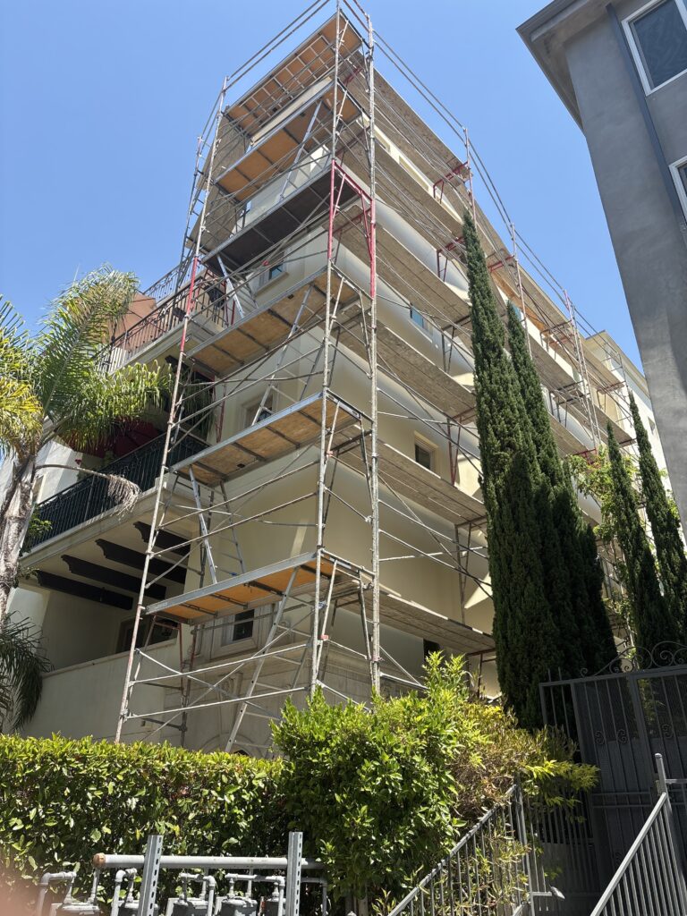 side of building with scaffolds for waterproofing the los angeles building